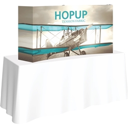 5ft Curved HopUp 2x1 Tabletop Fabric Trade Show Display with Full Fitted Graphic has a light weight, heavy duty frame that holds a fabric graphic mural. It sets up in seconds and can be packed away just as quickly after trade show or event