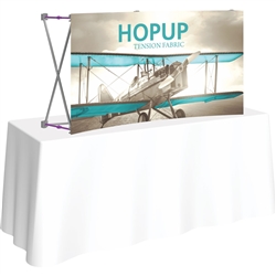 5ft Curved HopUp 2x1 Tabletop Fabric Trade Show Display with Front Graphic has a light weight, heavy duty frame that holds a fabric graphic mural. It sets up in seconds and can be packed away just as quickly after trade show or event