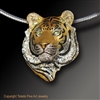 Tiger Pendant "I Am Tiger" by wildlife artist and jeweler Daniel C. Toledo, Toledo Wildlife Works of Art is created entirely by Dan in his studio in sterling silver and then plated in rhodium and 22k gold, black enamel, and peridot eyes.