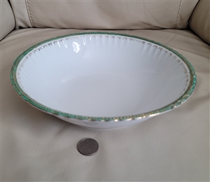 Preowned antique Victoria Austria porcelain round serving bowl featuring gold and green embossed scalloped edges