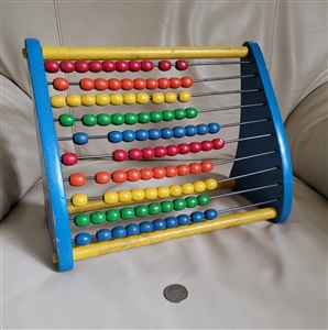 Vintage Playskool wooden abacus with colorful sliding beads and blue wooden sides showing gentle wear