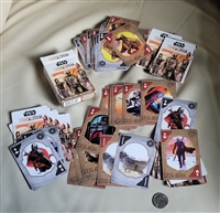 Open deck of Star Wars The Mandalorian playing cards spread out next to their original box and a coin marker for scale reference