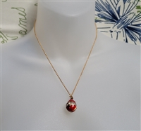 Guilloche style pendant egg with gold tone chain