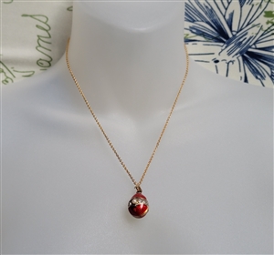 Guilloche style pendant egg with gold tone chain