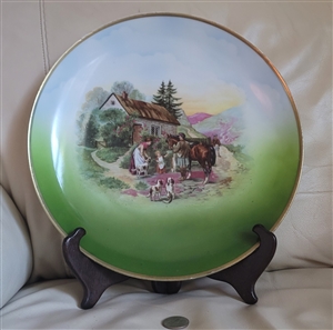 Large vintage German porcelain twelve inch decorative plate with colorful cottage and family scene