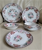 Antique Noritake Berkeley 1912 six piece porcelain place setting featuring hand painted floral designs and geometric borders on plates and teacup