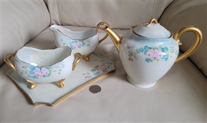 The main photo shows a 4 piece antique porcelain tea set with a matching pink rose design including a footed teapot with lid a footed creamer and an open sugar bowl all sitting on a rectangular serving tray with gold trim