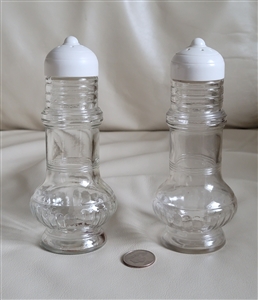 Tall clear glass salt or pepper shaker with topper