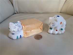 Two ceramic cats shakers table setting