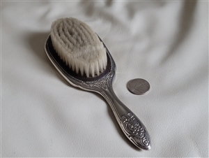 Silver tone embossed vanity hairbrush weighted silver tone encasing