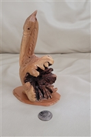 Handcrafted driftwood pelican sculpture on oval wood base