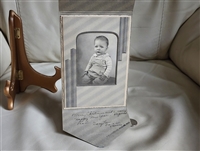 Vintage baby picture in a cardboard envelope frame