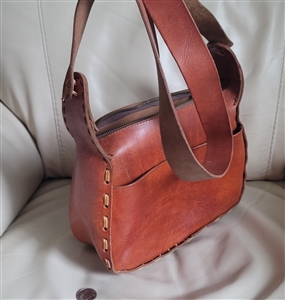 Handcrafted brown leather shoulder bag accessory