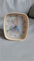 The front view shows a square 1992 Precious Moments Westclox alarm clock with a pale pink frame and a girl hugging a goose on the dial next to the text Waddle I Do Without You