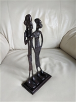 Cast metal African tribal men and women statue
