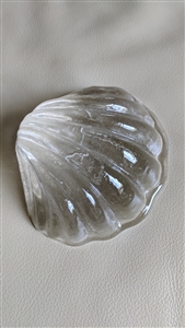 This preowned vintage clear art glass seashell paperweight is signed Loranger 2006 with a palm tree imprint