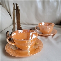Set of two preowned vintage Anchor Hocking Peach Lustre Laurel glass teacups and saucers