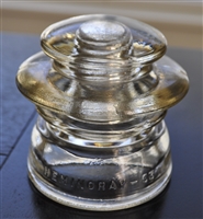 Yellow Hemingray 53 glass insulator with embossed text