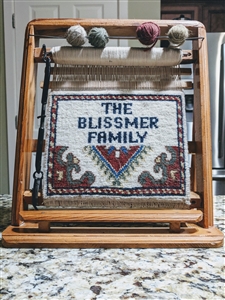 Rug weaving loom souvenir with finished carpet