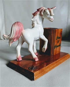Unicorn toy on wooden stand pen and pencil holder