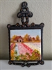 Vintage trivet with hand painted decorative tile