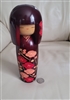 Japanese wooden Kokeshi doll with carved design