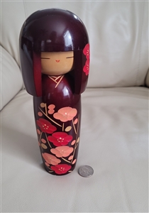 Japanese wooden Kokeshi doll with carved design