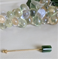 Long gold tone hat pin with greens stone accent