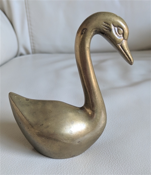 Vintage brass swan sculpture paperweight and decorative display.