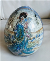 Front view of a vintage Geisha Satsuma style porcelain egg featuring raised Moriage floral designs and an intentional crackle glaze finish