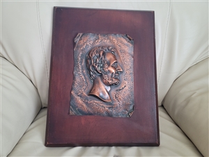 Copper Lincoln plaque on wooden backing wall decor