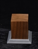 Wood base kit comprised of a polished walnut body and a 3D printed resin decorative foot/pedestal. It includes a wood screw and magnetic strip.  The body measures at 1.5 x 1.5 x 1.75 inches and the foot/pedestal measures at 2 x 2 x 3/8 inches.