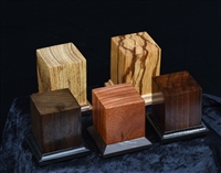 Wood Bases produced by United Empire.  Various exotic woods measuring approximately 2" x 2" x 2".  Felt Pads and decorative foot included.