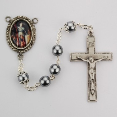 Saint Joan of Arc rosary has hematite beads, an image of St.  Joan of Arc for a rosary center and a pewter crucifix. Gift boxed.