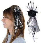 The Skeleton Hand Hair Clip adds a subtle touch to your Halloween outfit. Not overly creepy, it features a silver plastic skeleton hand affixed to a black hair clip. Black feathers, and black tulle fabric feature silver and gold accents. No returns.