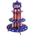 The Patriotic Cupcake Stand has red and white stripes and the tiers are blue with white stars. It measures 16 inches tall and has three tiers. Made of cardstock. Contains one per package. Simple assembly required.