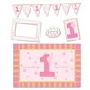 1st Birthday High Chair Decorating Kit - Pink features a plastic chair mat, card stock items including photo fun frame, sign, and streamer, plus a felt crown for the guest of honor. All items in a coordinating color palette of pinks, gold, and white.