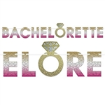 The Bachelorette Streamer is made of cardstock coated in glittered foil and printed on one side. It's gold, silver, and pink and a gold ring icon. It measures 7 inches tall and 6 feet long. Contains one per package. Simple assembly required
