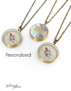 Image depicts 3 small brass compasses on darkened brass chains; two showing the back navigation side of the compass, one showing the front with map and quote design.  The navigation side is white with a silver & red needle. Each map and quote are custom.