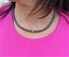 Snake choker necklace with rhinestone center.