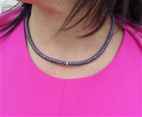 Snake choker necklace with rhinestone center.